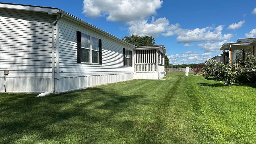 Freshly mowed lawn with mowing stripes beside a home in Akron, NY